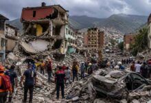 Rescue workers searching damaged buildings after a powerful earthquake in Venezuela