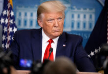 Donald Trump speaking during a public event amid debate over health claims made by Mary Trump