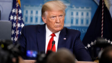 Donald Trump speaking during a public event amid debate over health claims made by Mary Trump