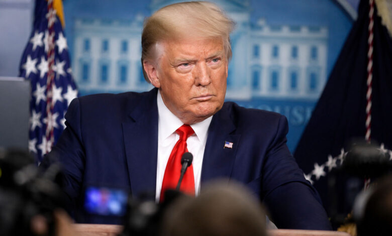 Donald Trump speaking during a public event amid debate over health claims made by Mary Trump