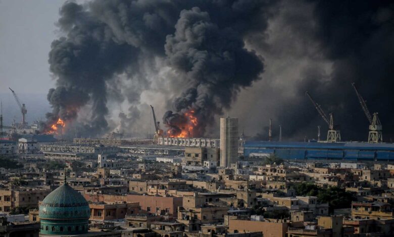 Smoke rising after reported explosions in southern Iran as emergency responders monitor the affected area.