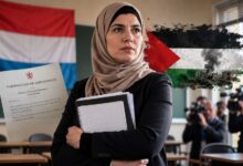 Luxembourg teacher Fatima Kartich at a classroom podium as debate continues over her dismissal following pro-Palestine social media posts.