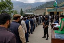 Voters casting ballots at a polling station during the second phase of the Azad Kashmir Elections 2026 under security arrangements in Muzaffarabad.