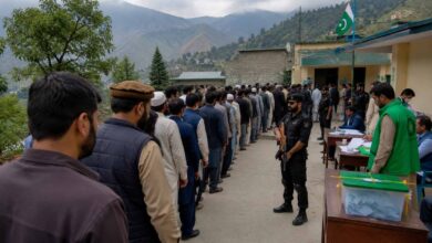 Voters casting ballots at a polling station during the second phase of the Azad Kashmir Elections 2026 under security arrangements in Muzaffarabad.